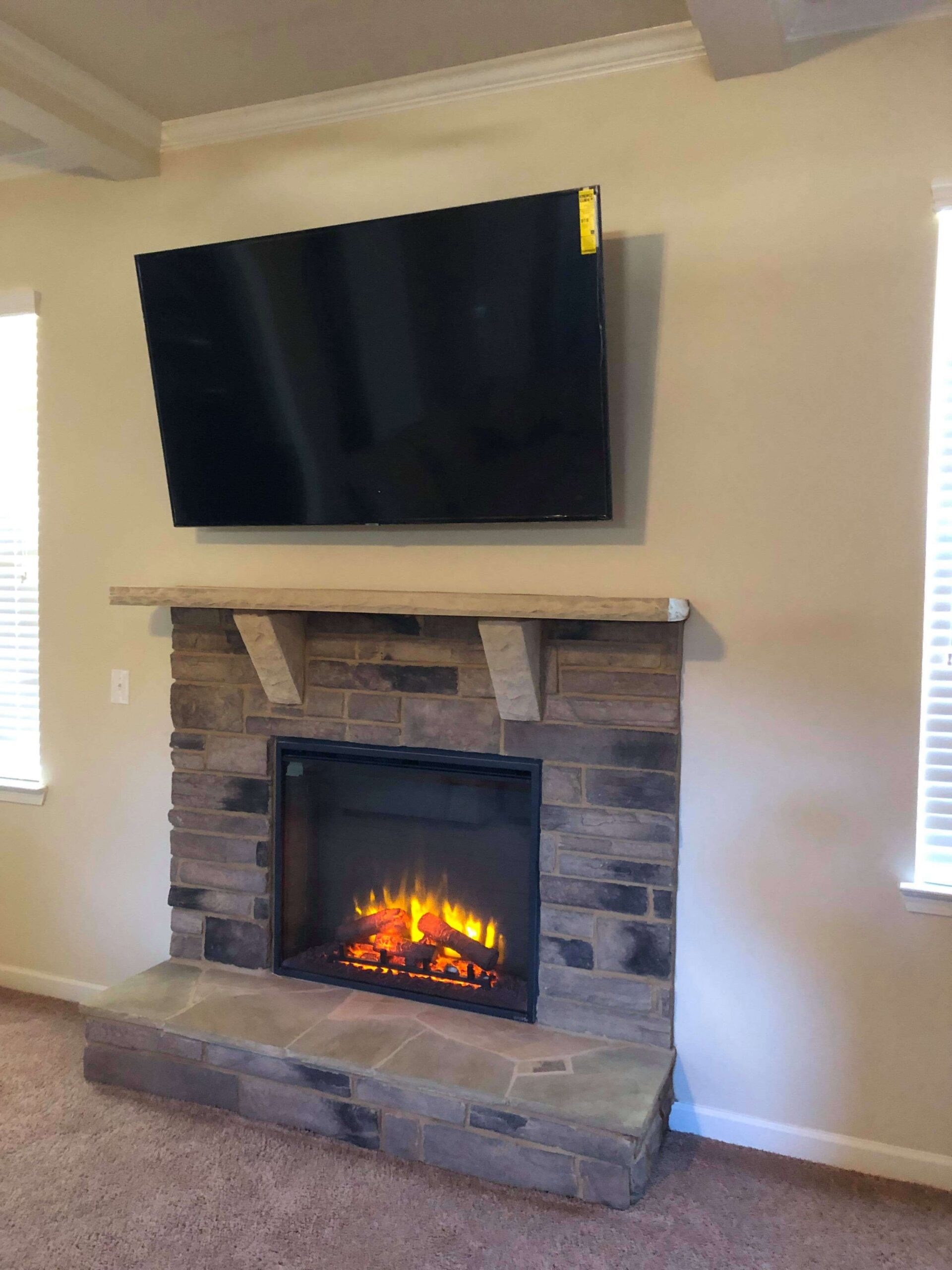 brilliant 70 inch tv above a fireplace in sandy springs, ga | tv mounting service tv mounted on stone fireplace image