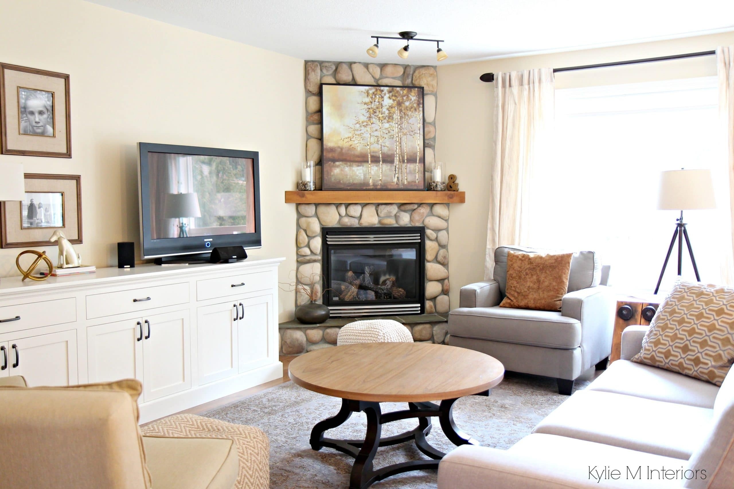 image of south facing living room with stone corner fireplace, furniture, home where to put tv in living room with fireplace picture