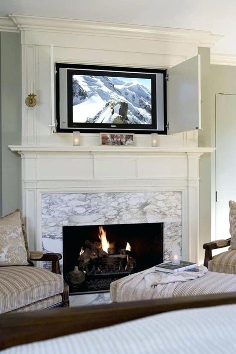 image of tv above fireplace hiding a flat panel | home fireplace flat screen tv on fireplace mantel picture