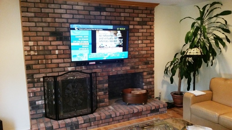 outstanding flat screen tv mounting over brick fireplace | south hampton, ny mounting a tv to a brick fireplace image