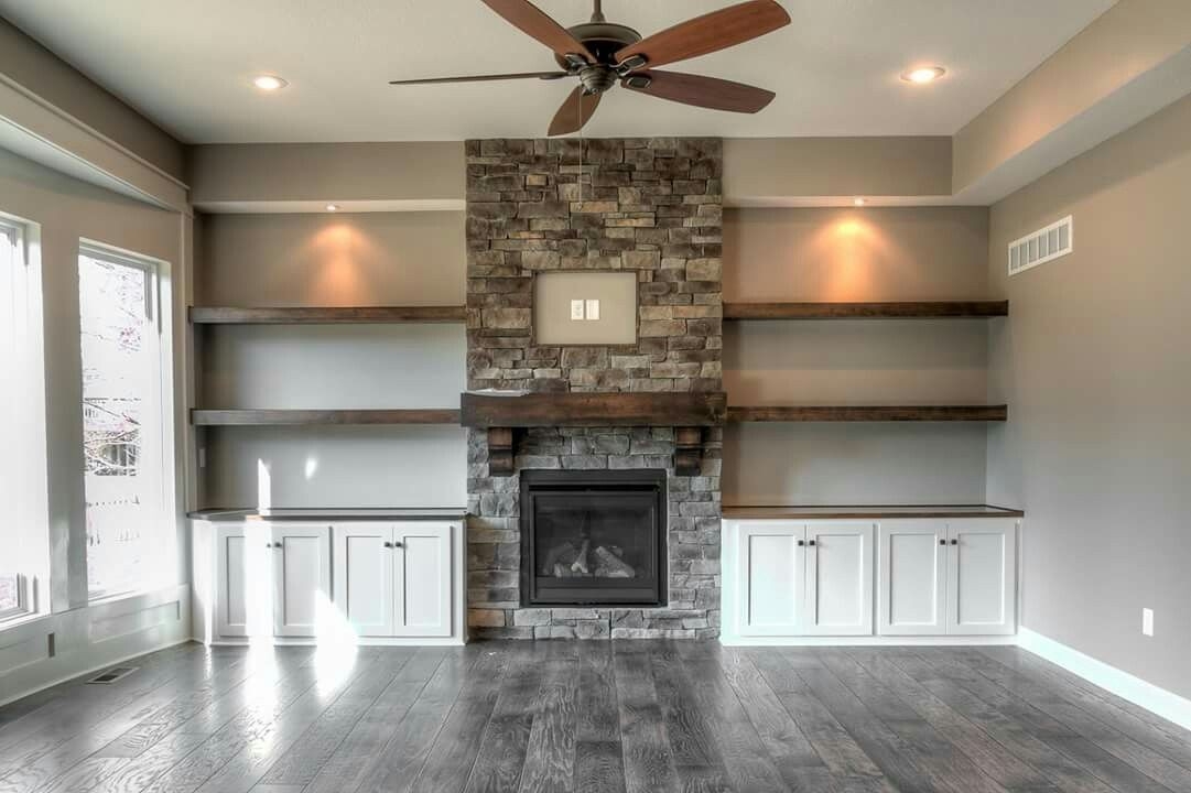 best love the wall design of stone, shelves, cabinets, can lights and built in cabinets beside fireplace picture