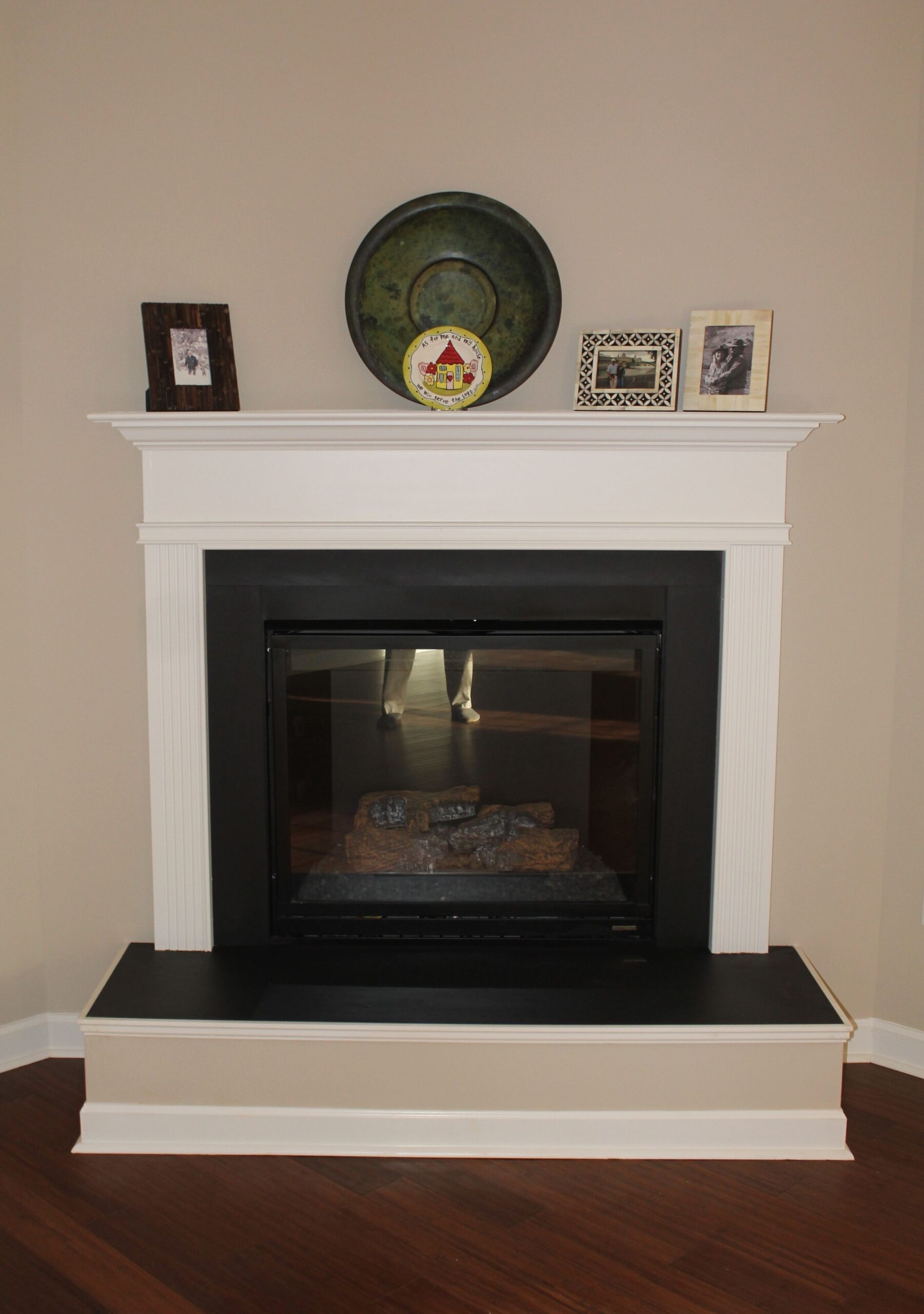 image of a corner gas fireplace with a raised hearth, slate surround and wood slate tiles for fireplace surround image