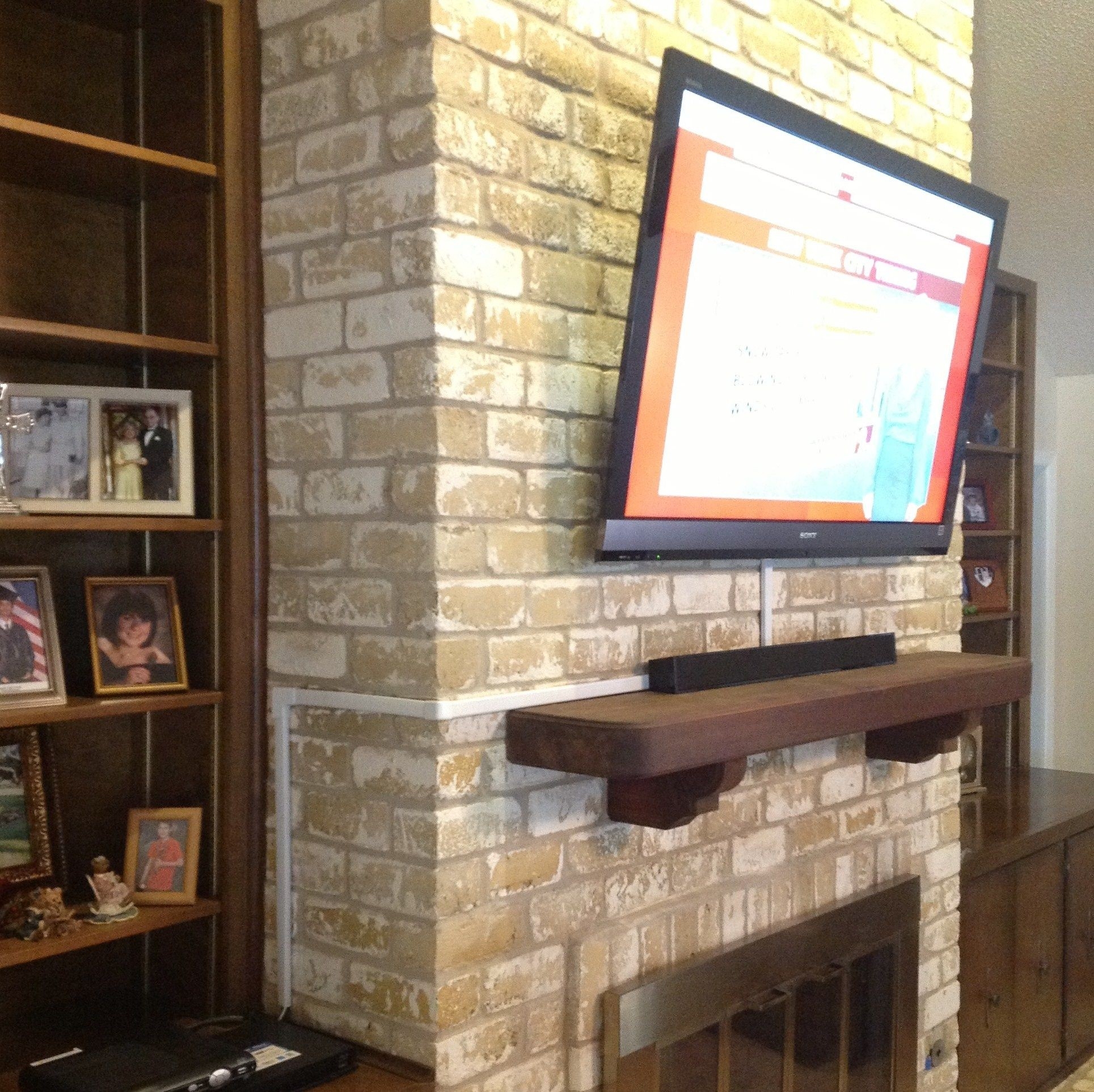 image of vesta tv installation over a fireplace pictures | fireplace pictures how to hide tv wires over brick fireplace image