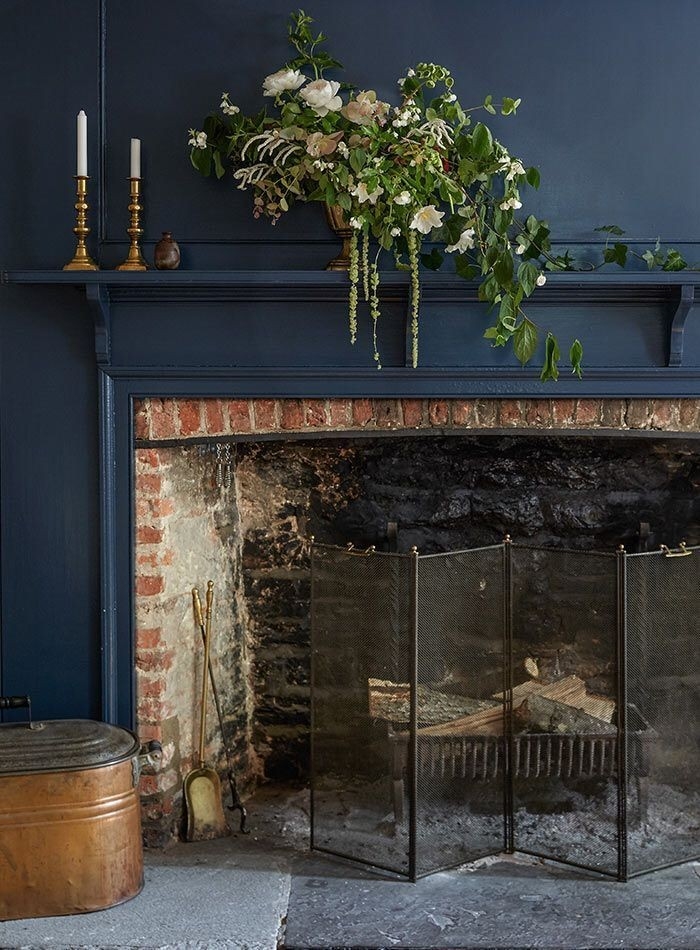 stunning fireplace embraced in wonderful blue | fireplace, dark interiors black paint for fireplace interior picture