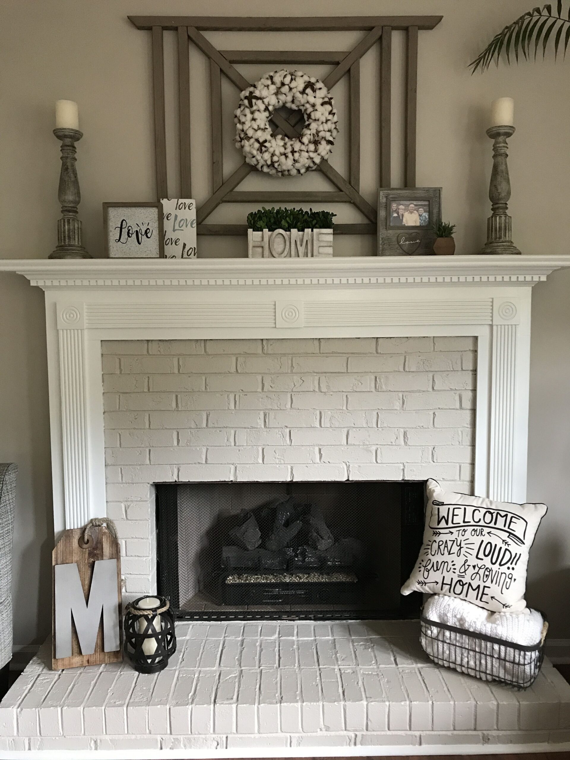 top painted brick fireplace and mantle with cotton wreath | farmhouse shabby chic brick fireplace image